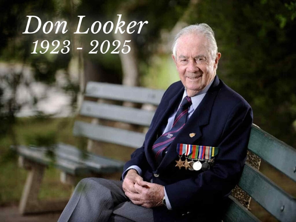 Image of Don Looker on a green bench.