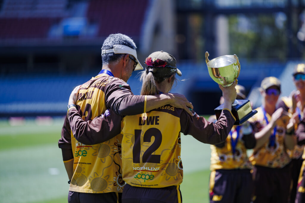 Kensington Women's 1st Coach and Captain facing away from the camera celebrating the Season 2025/26 T20 at Adelaide Oval.